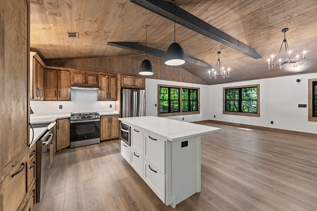 570 Cabin Trail Blue Ridge, GA 30513 - Photo 20 of 53 a kitchen with a stove window and wooden floor