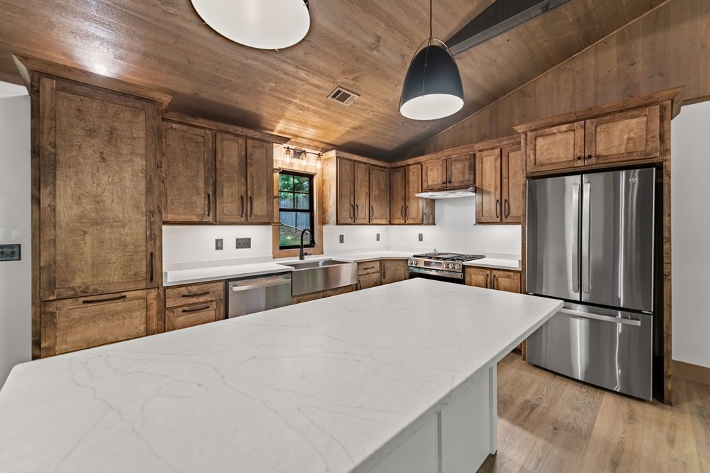 570 Cabin Trail Blue Ridge, GA 30513 - Photo 21 of 53 a kitchen with stainless steel appliances a refrigerator sink and cabinets