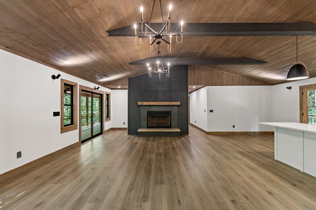 570 Cabin Trail Blue Ridge, GA 30513 - Photo 24 of 53 a view of an empty room with wooden floor fireplace and a window