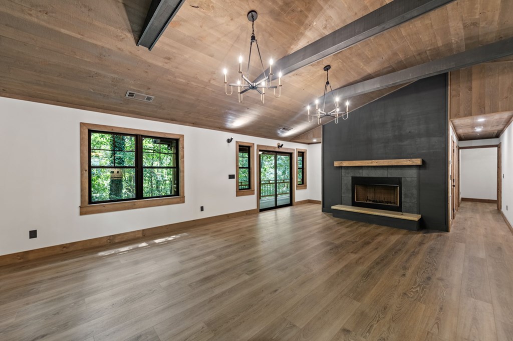 570 Cabin Trail Blue Ridge, GA 30513 - Photo 25 of 53 a view of an empty room with wooden floor fireplace and a window