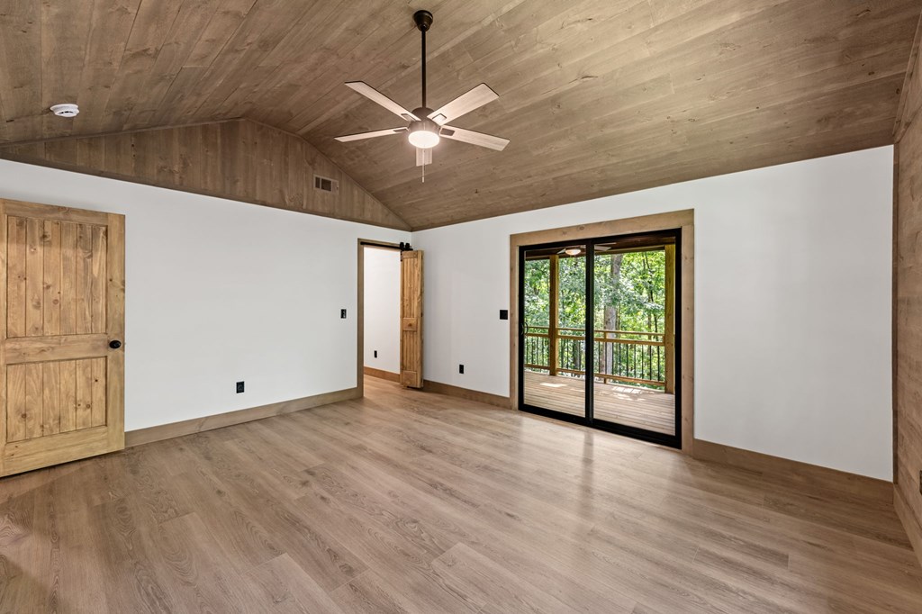 570 Cabin Trail Blue Ridge, GA 30513 - Photo 28 of 53 a view of an empty room with wooden floor and a window