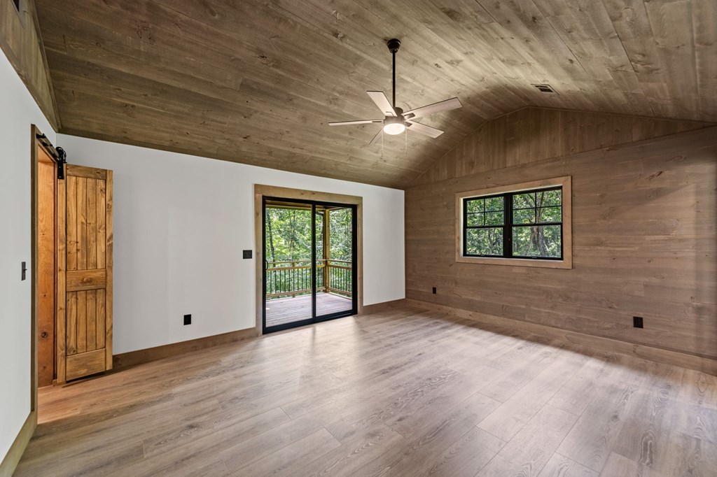 570 Cabin Trail Blue Ridge, GA 30513 - Photo 29 of 53 a view of an empty room with a window and wooden floor