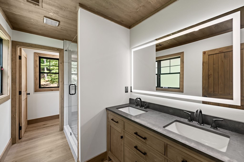 570 Cabin Trail Blue Ridge, GA 30513 - Photo 32 of 53 a bathroom with a granite countertop sink and a mirror