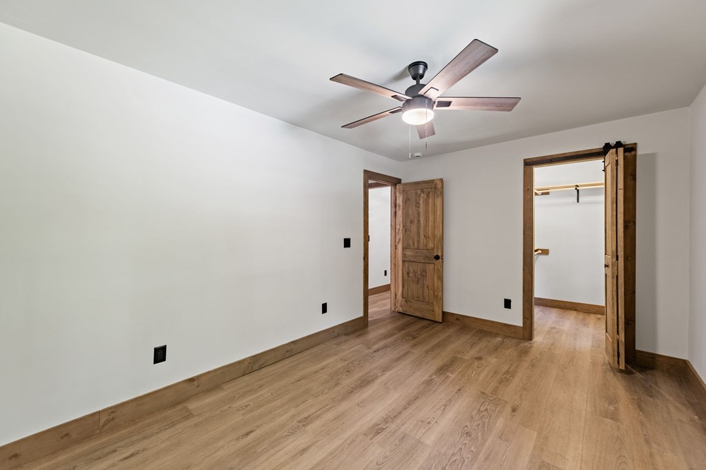 570 Cabin Trail Blue Ridge, GA 30513 - Photo 36 of 53 an empty room with wooden floor fan and windows