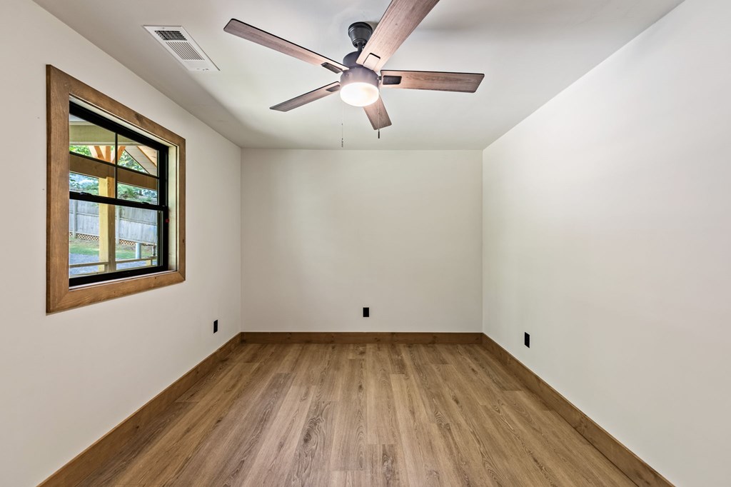 570 Cabin Trail Blue Ridge, GA 30513 - Photo 37 of 53 a view of empty room with wooden floor and fan