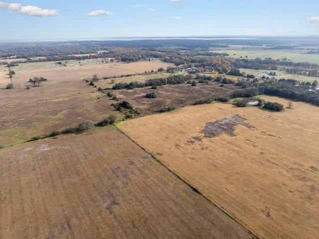 a view of a yard with wooden fence