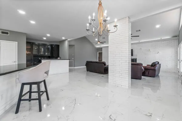 a large kitchen with a table and chairs