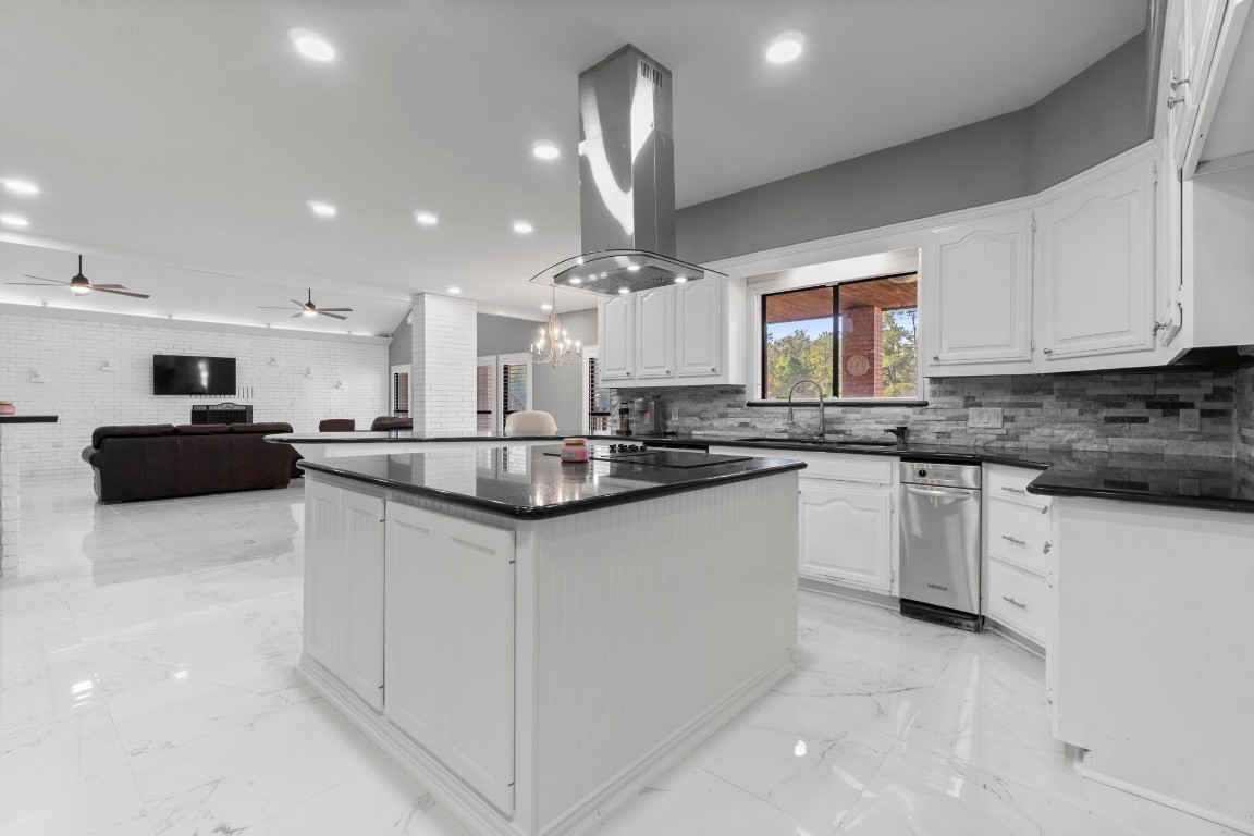 22405 Augusta Lane Point Blank, TX 77364 - Photo 16 of 50 a kitchen with stainless steel appliances kitchen island granite countertop a sink and cabinets