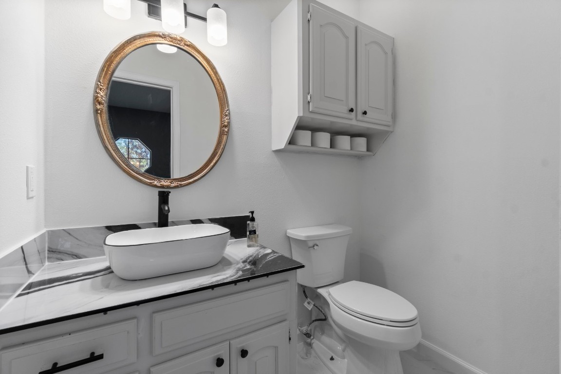 22405 Augusta Lane Point Blank, TX 77364 - Photo 20 of 50 a bathroom with a toilet sink and mirror