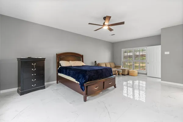 a spacious bedroom with a bed and window