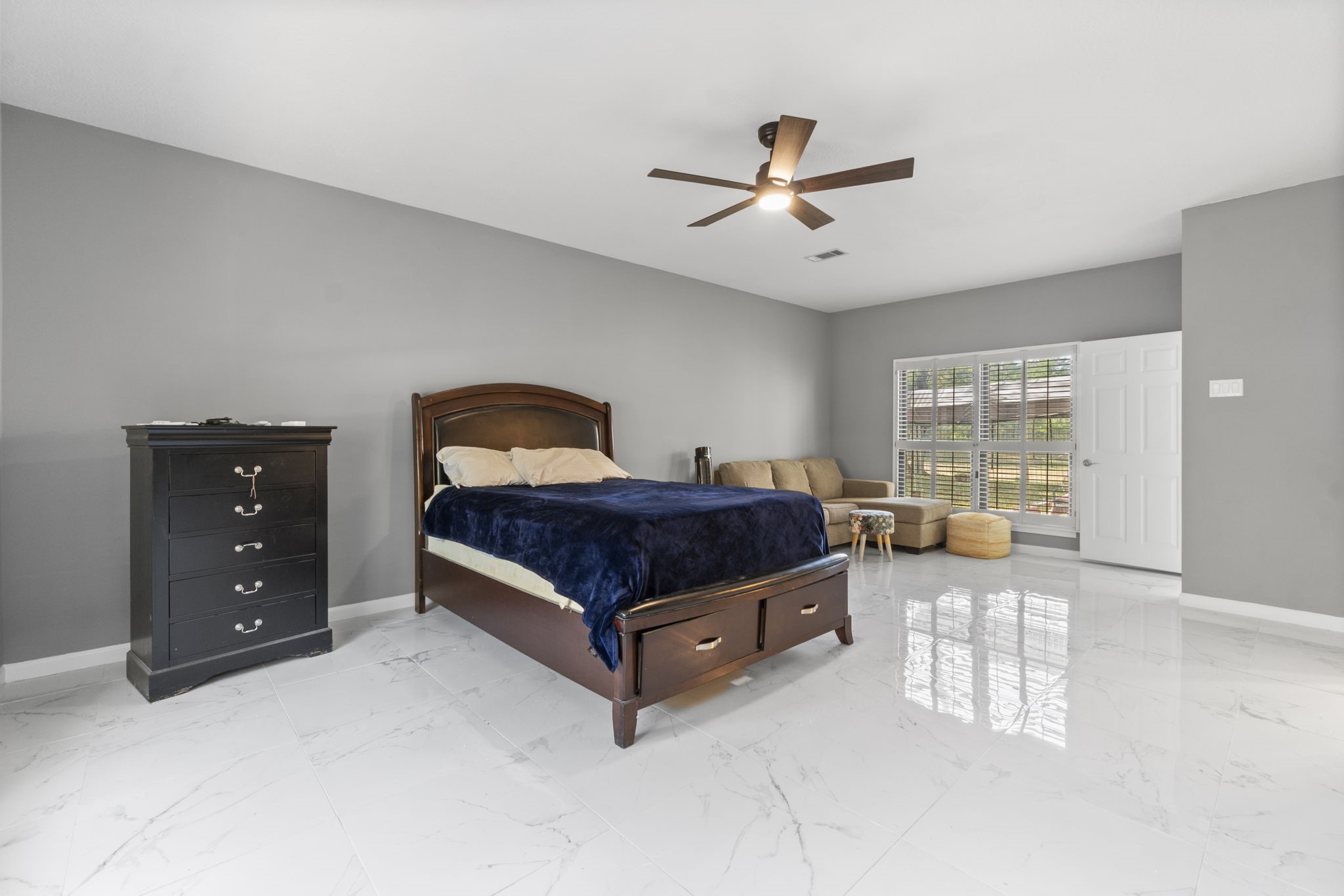 22405 Augusta Lane Point Blank, TX 77364 - Photo 23 of 50 a spacious bedroom with a bed and window