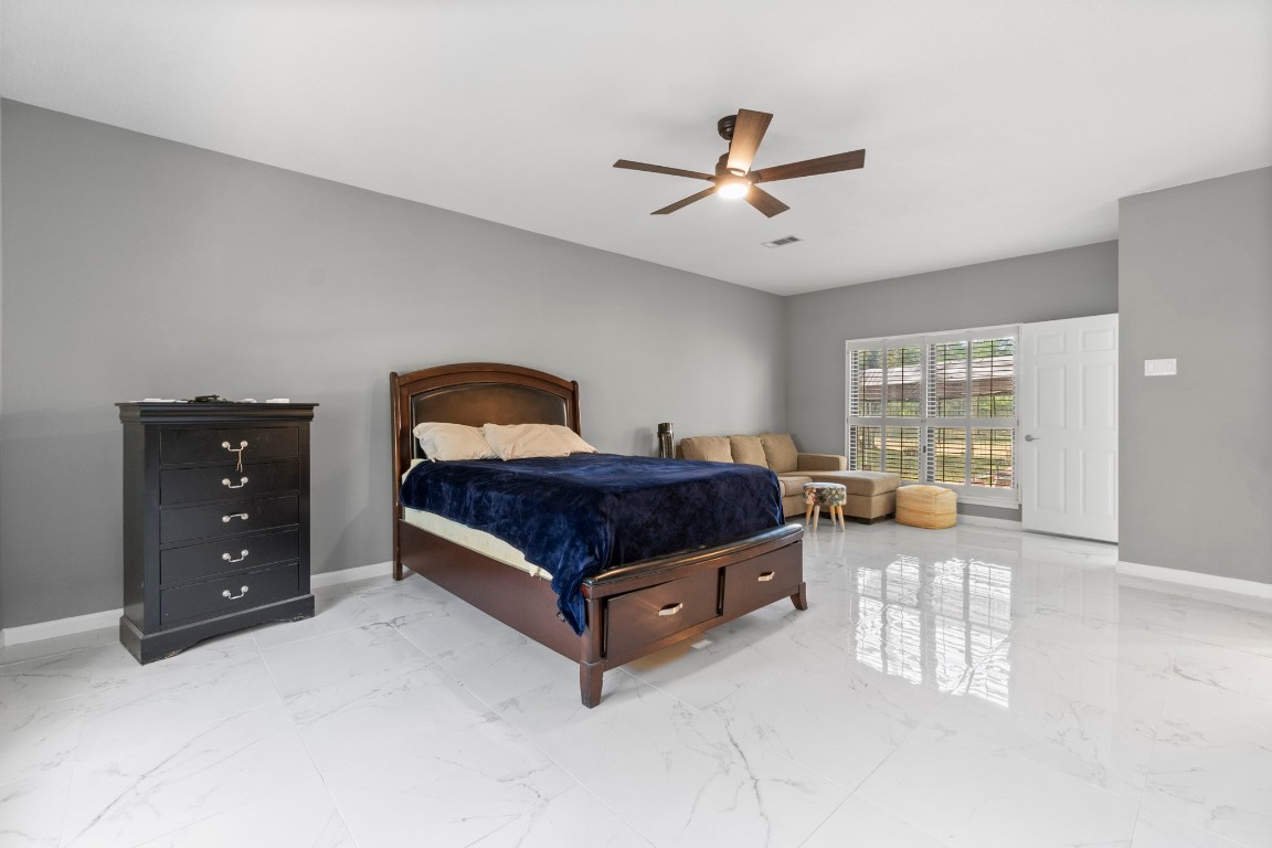 22405 Augusta Lane Point Blank, TX 77364 - Photo 23 of 50 a spacious bedroom with a bed and window