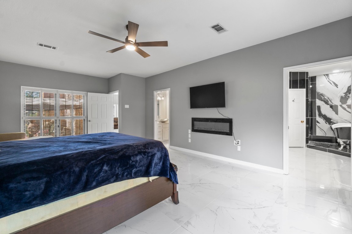 22405 Augusta Lane Point Blank, TX 77364 - Photo 24 of 50 a bedroom with a bed and a flat screen tv