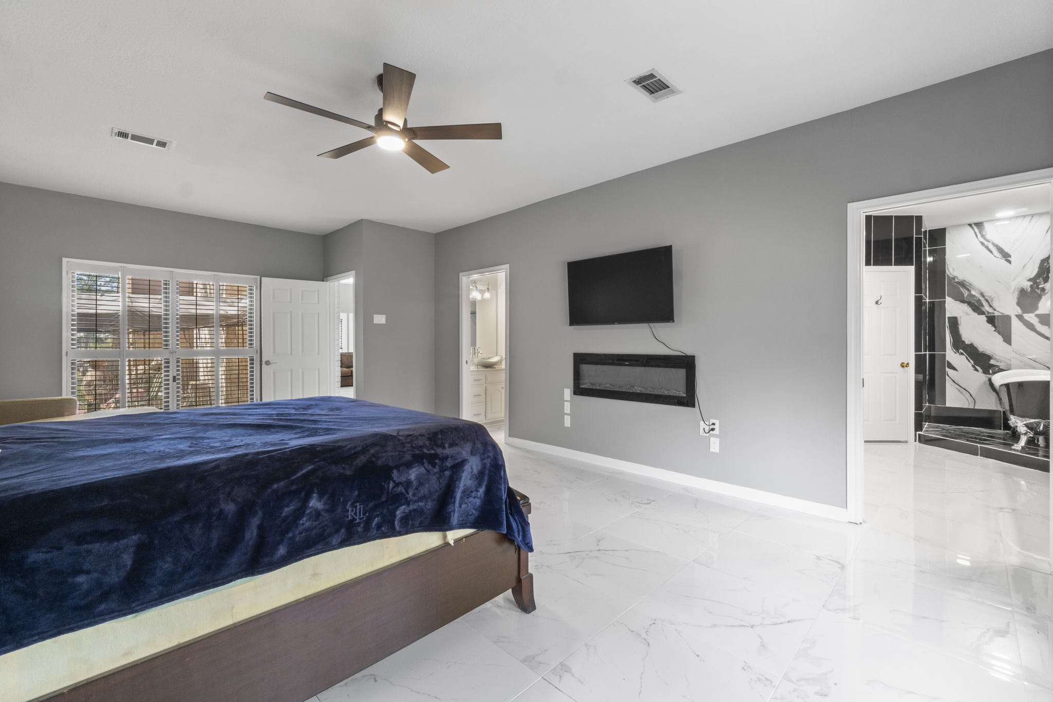 22405 Augusta Lane Point Blank, TX 77364 - Photo 24 of 50 a bedroom with a bed and a flat screen tv