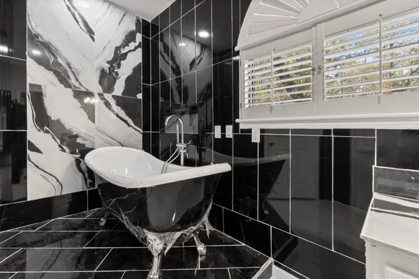 a bathroom with a toilet a sink and mirror