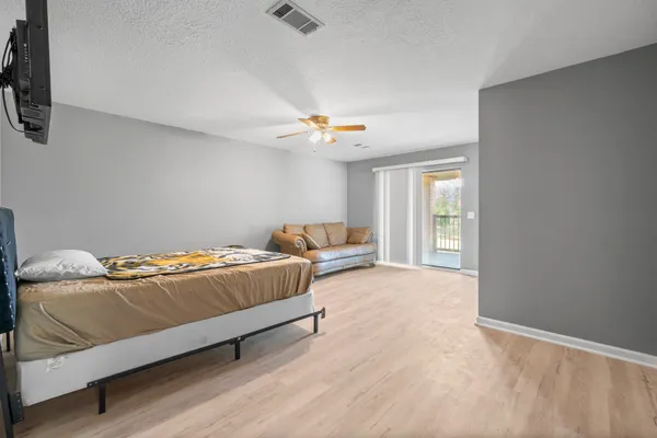 a bedroom with a bed and a chandelier