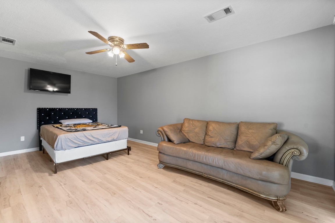 22405 Augusta Lane Point Blank, TX 77364 - Photo 32 of 50 a living room with furniture and a flat screen tv