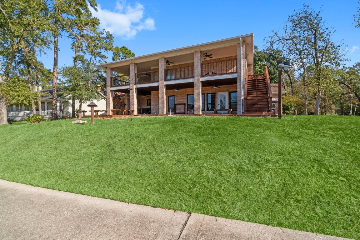 22405 Augusta Lane Point Blank, TX 77364 - Photo 41 of 50 a view of a building with a yard