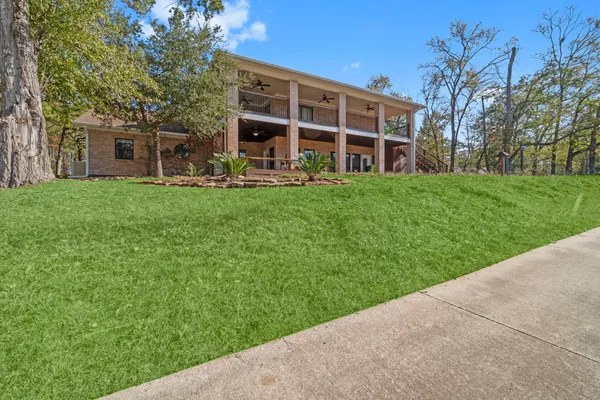 a view of a house with a yard and sitting area