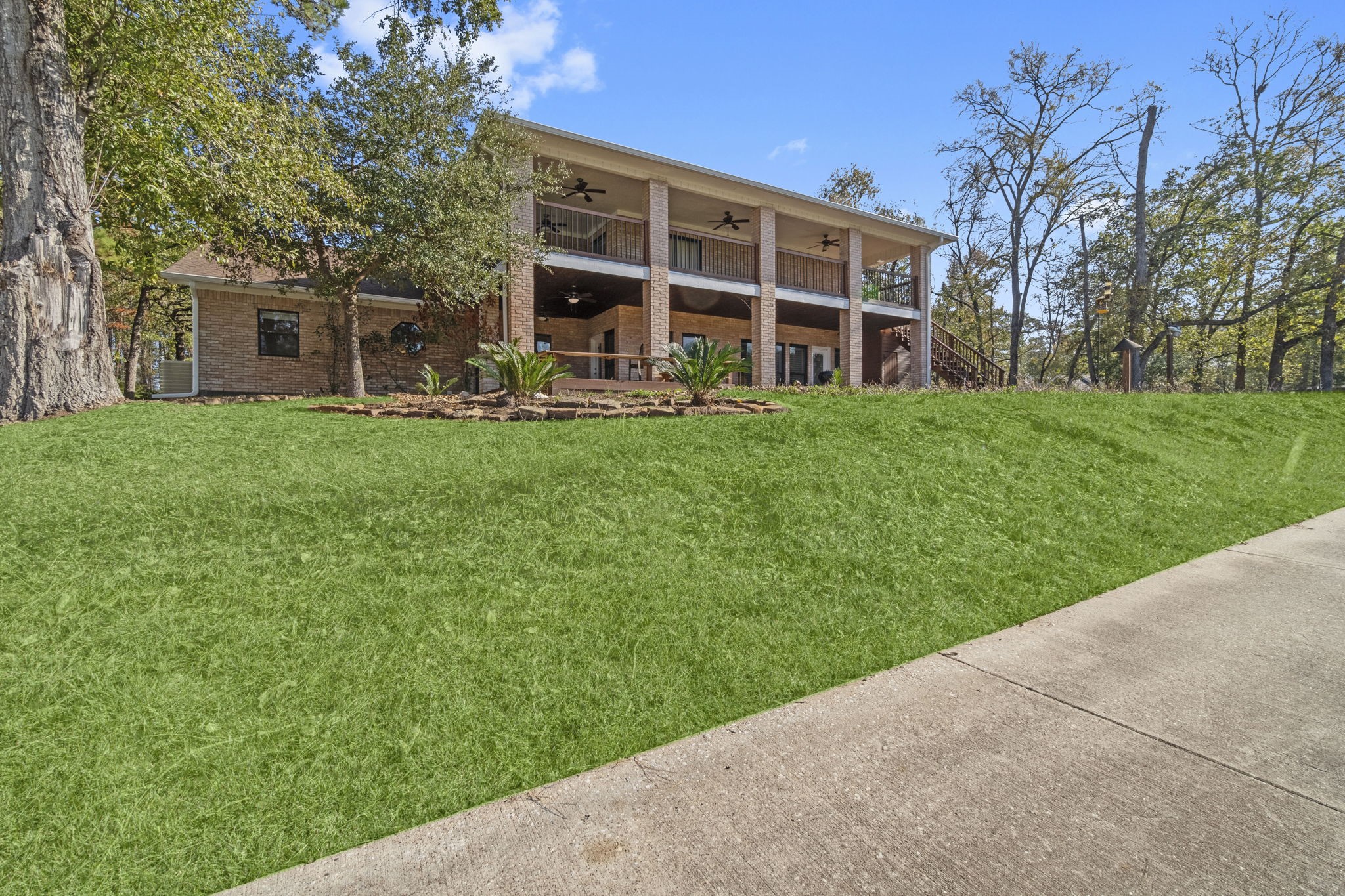 22405 Augusta Lane Point Blank, TX 77364 - Photo 42 of 50 a view of a house with a yard and sitting area