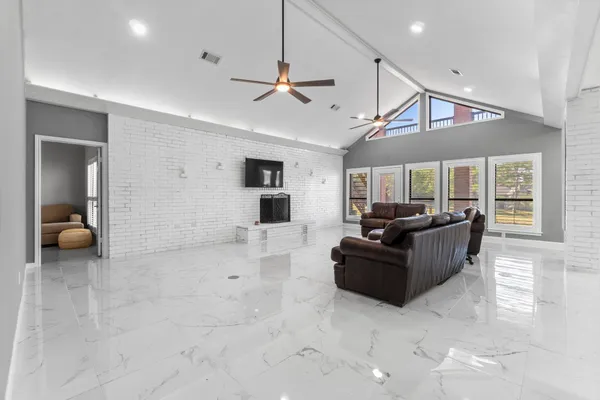 a living room with furniture and a ceiling fan