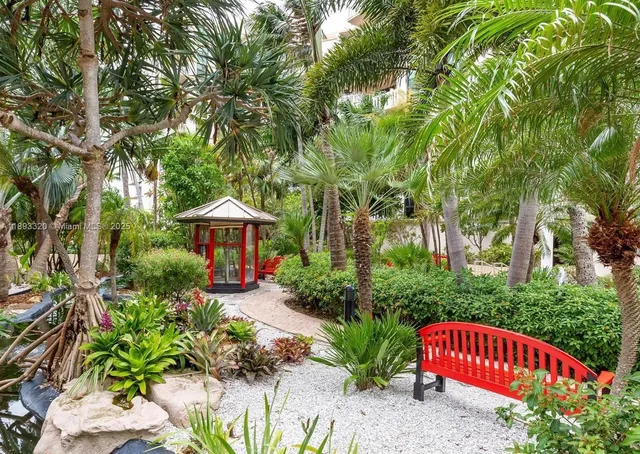 a view of a garden with a bench and plants