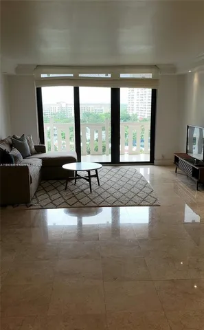 a living room with furniture and large windows