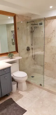 a bathroom with a toilet sink and shower
