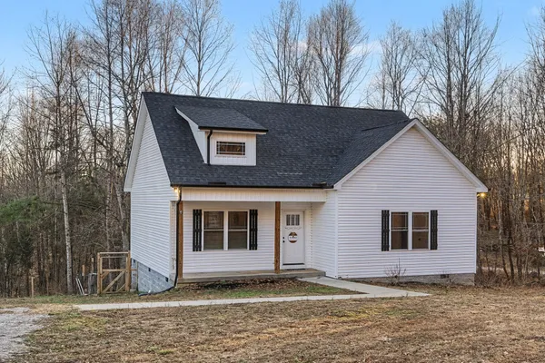 a house that has a tree in front of it