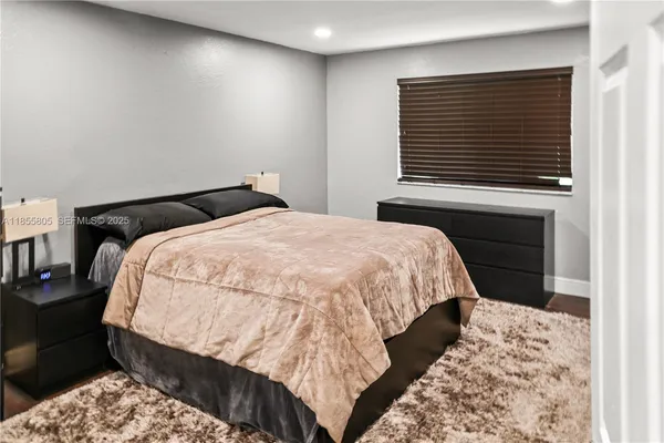 a bed sitting in a bedroom next to a window