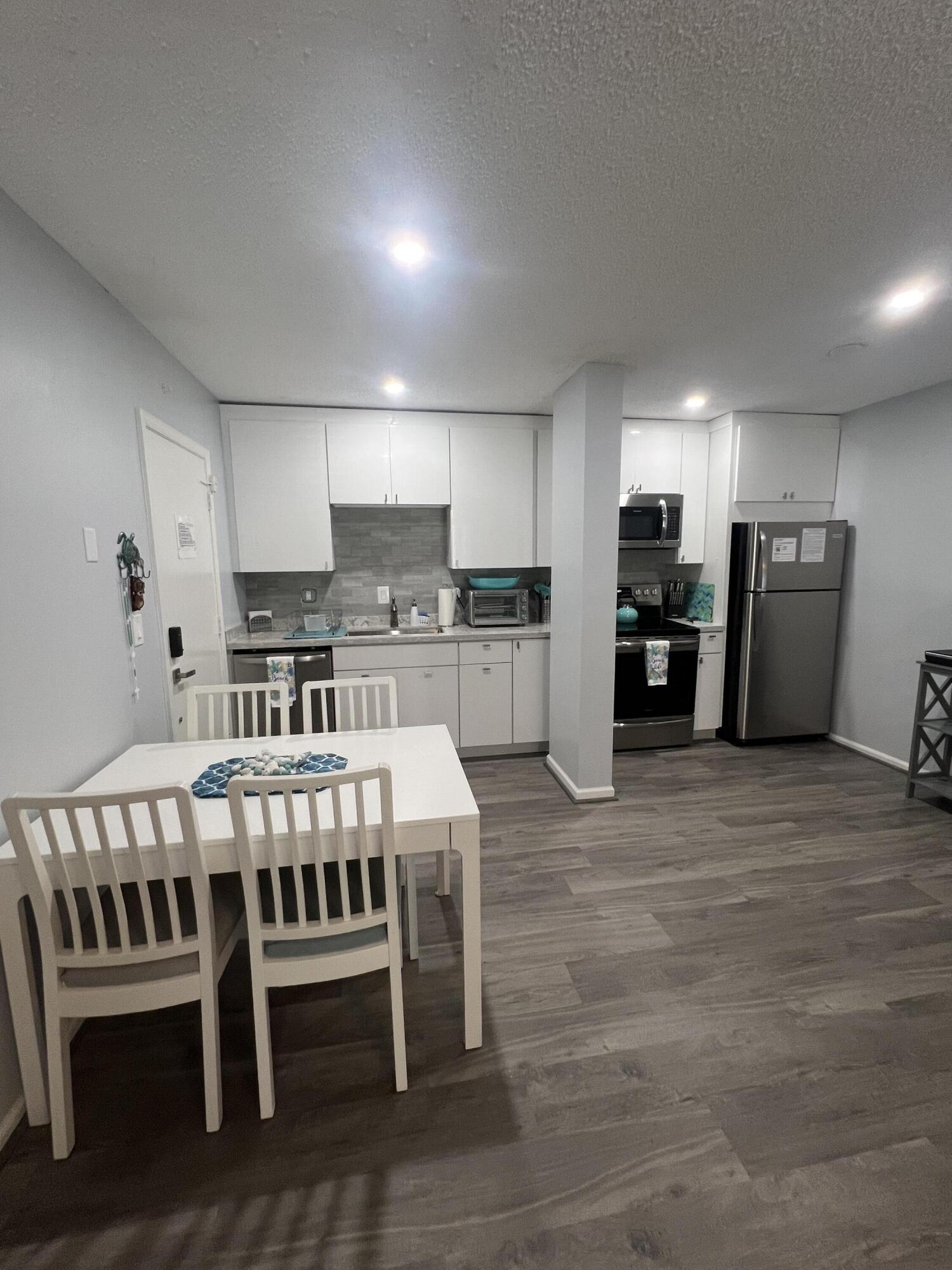 a large kitchen with a table and chairs