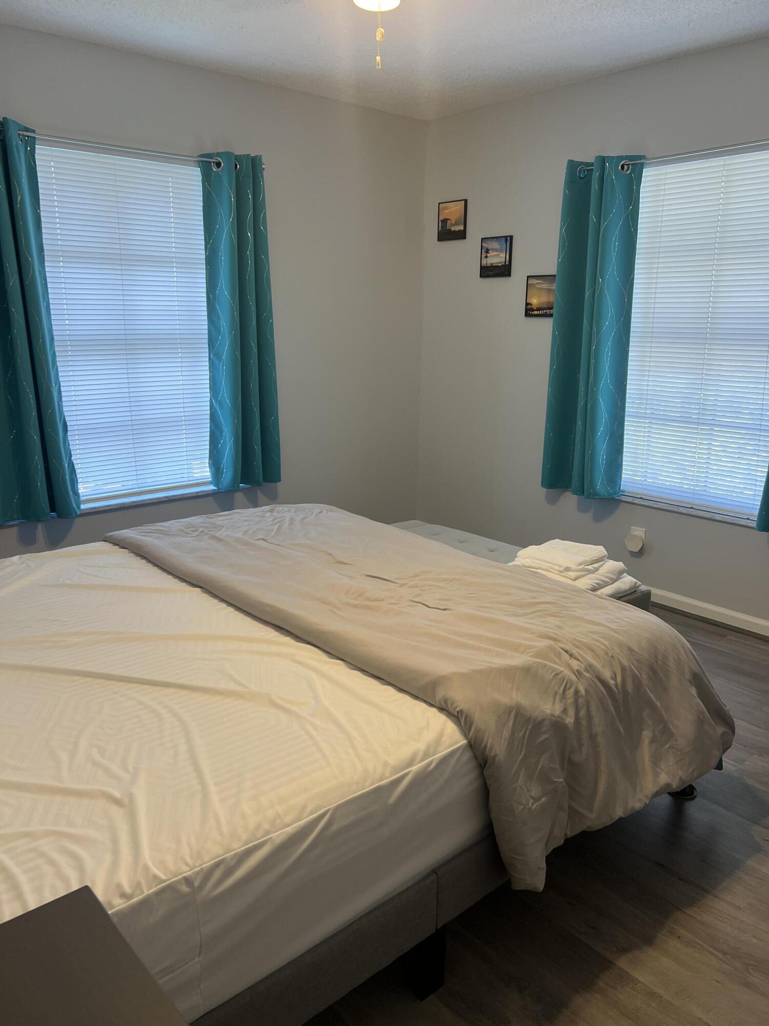 2271 Northeast 68th Street, Unit 2022 Fort Lauderdale, FL 33308 - Photo 13 of 22 a bedroom with a bed and wooden floor