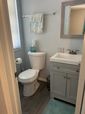 a bathroom with a toilet sink and mirror