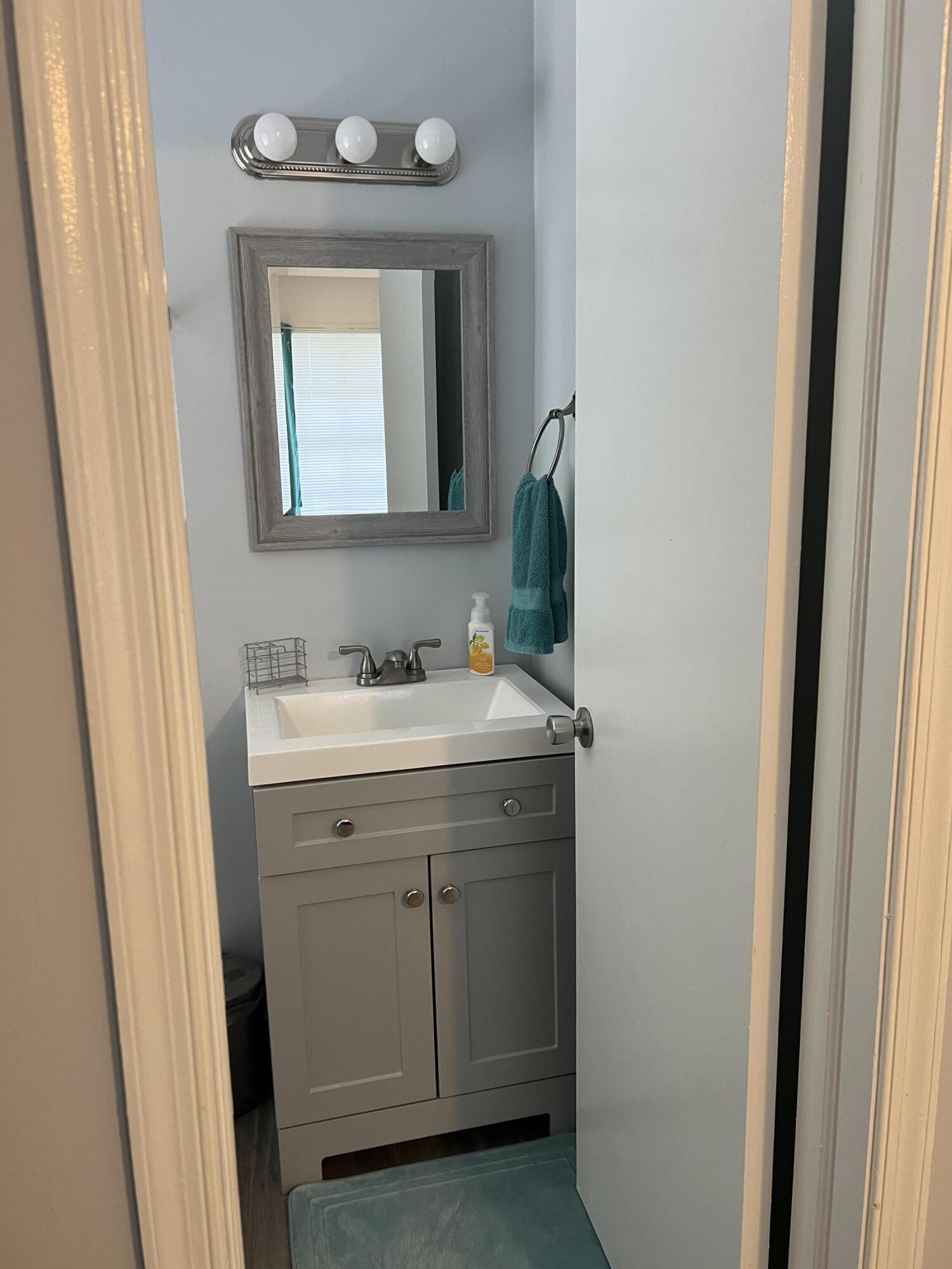 2271 Northeast 68th Street, Unit 2022 Fort Lauderdale, FL 33308 - Photo 16 of 22 a bathroom with a sink and a mirror