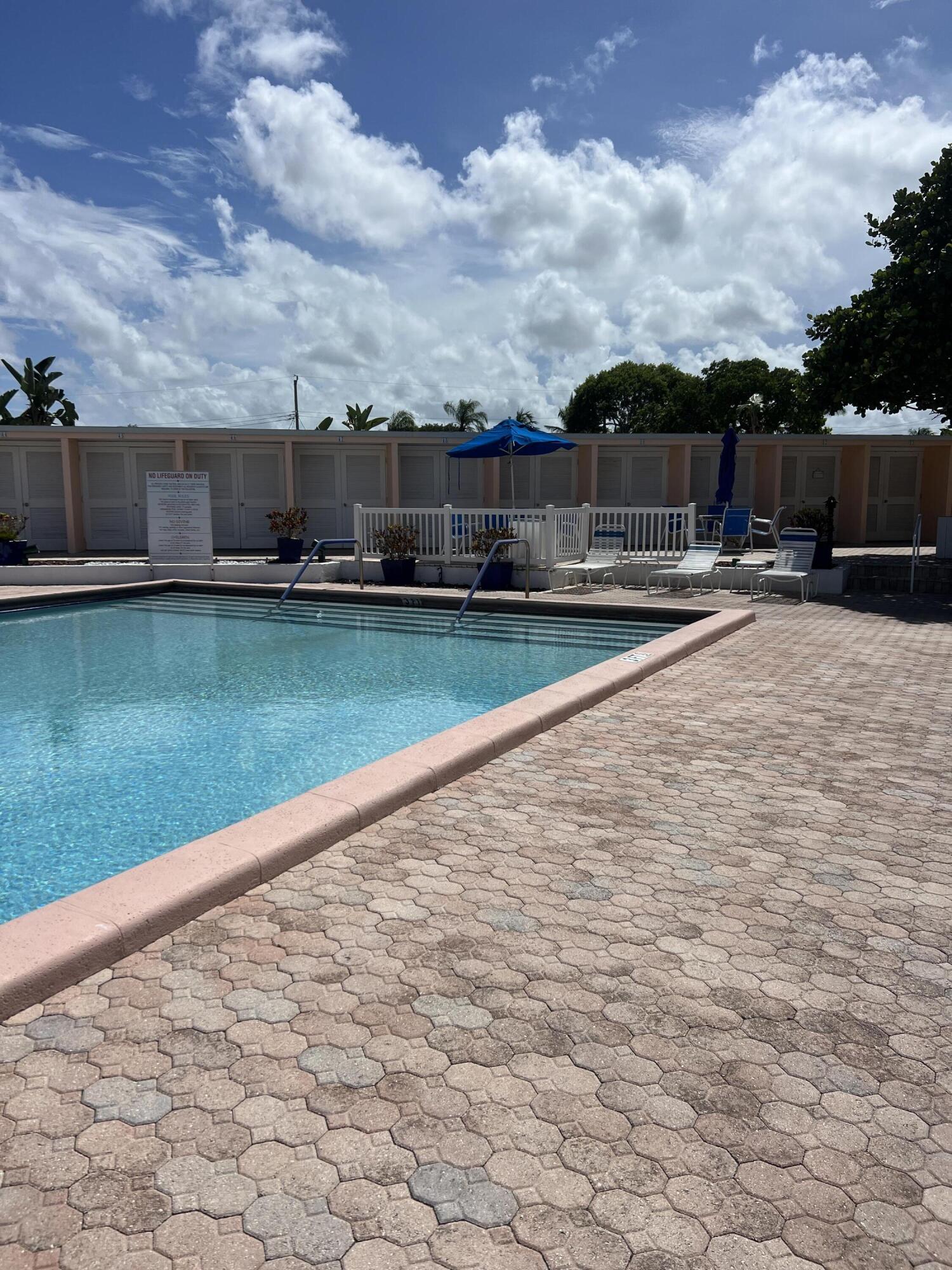 2271 Northeast 68th Street, Unit 2022 Fort Lauderdale, FL 33308 - Photo 19 of 22 a swimming pool with outdoor seating and barbeque oven