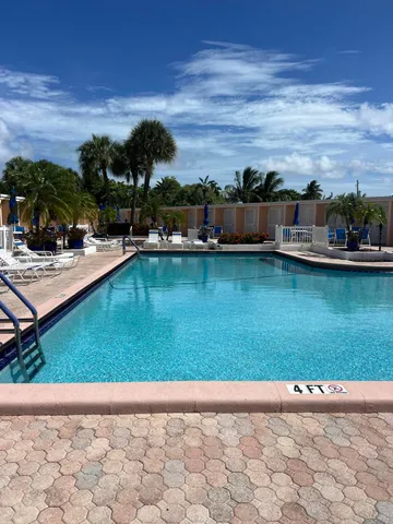 a view of a swimming pool with lounge chair