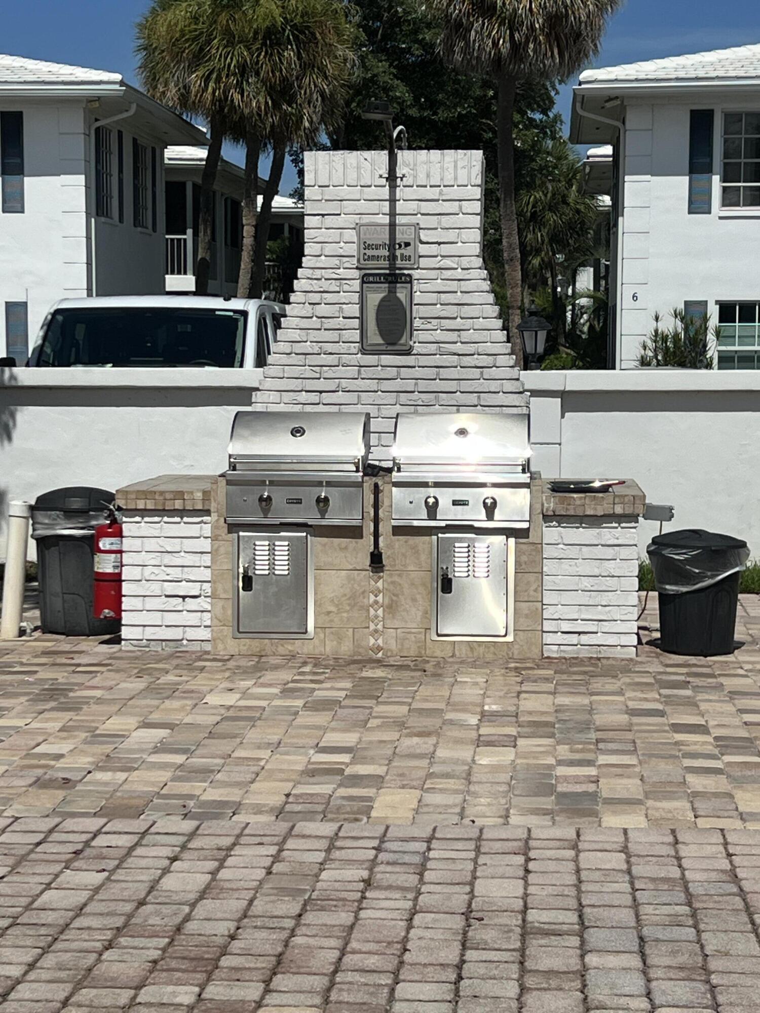 2271 Northeast 68th Street, Unit 2022 Fort Lauderdale, FL 33308 - Photo 21 of 22 a view of a patio with table and chairs with wooden fence