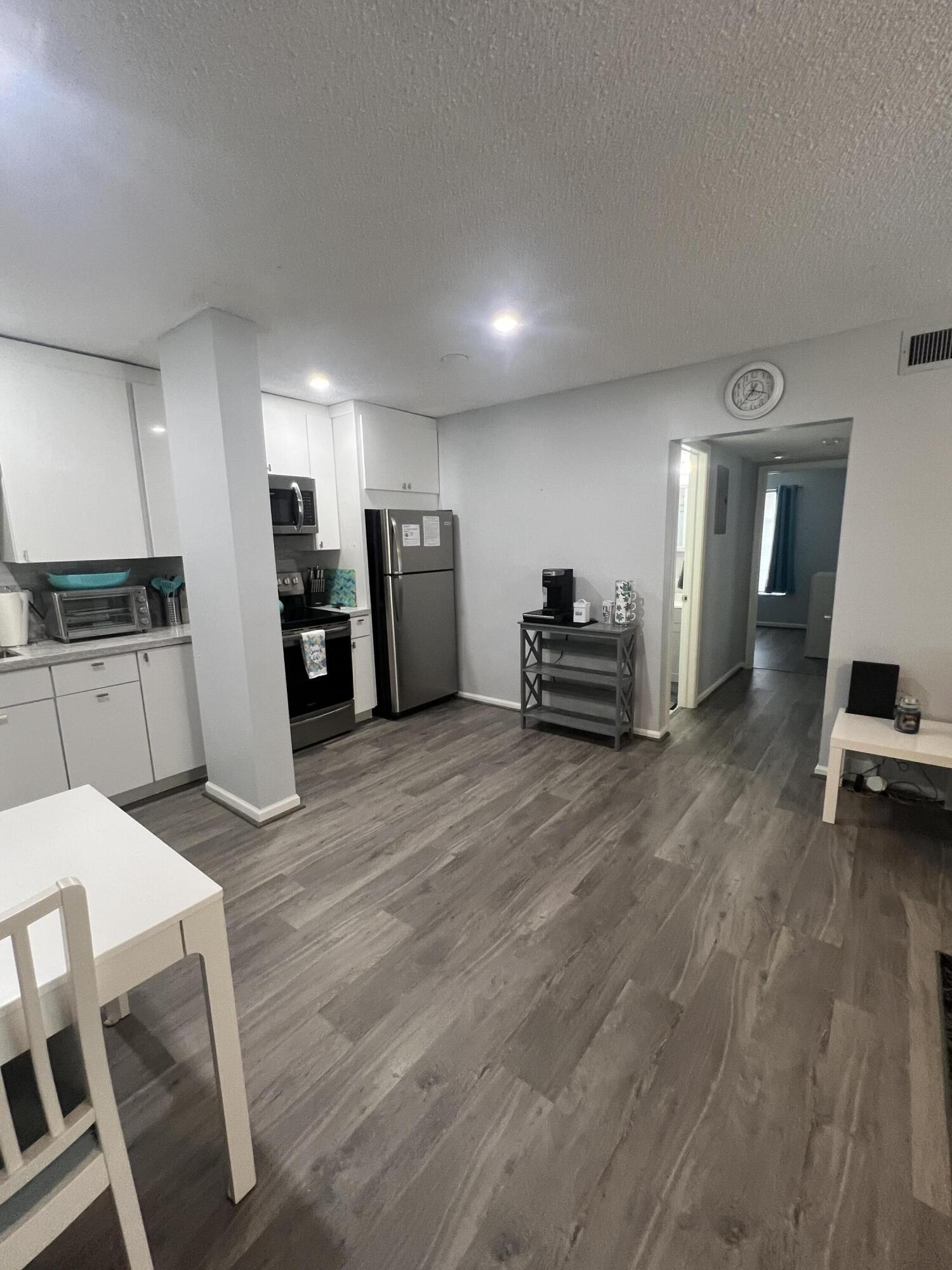 2271 Northeast 68th Street, Unit 2022 Fort Lauderdale, FL 33308 - Photo 4 of 22 a living room with furniture and a wooden floor