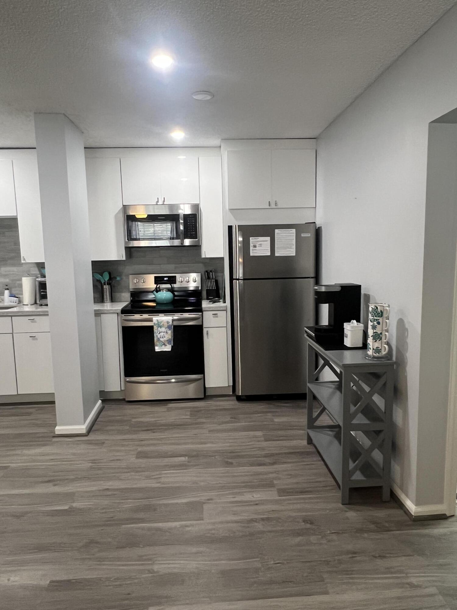 2271 Northeast 68th Street, Unit 2022 Fort Lauderdale, FL 33308 - Photo 5 of 22 a kitchen with a refrigerator and a stove top oven