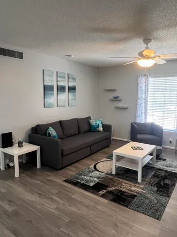 a living room with furniture and a large window