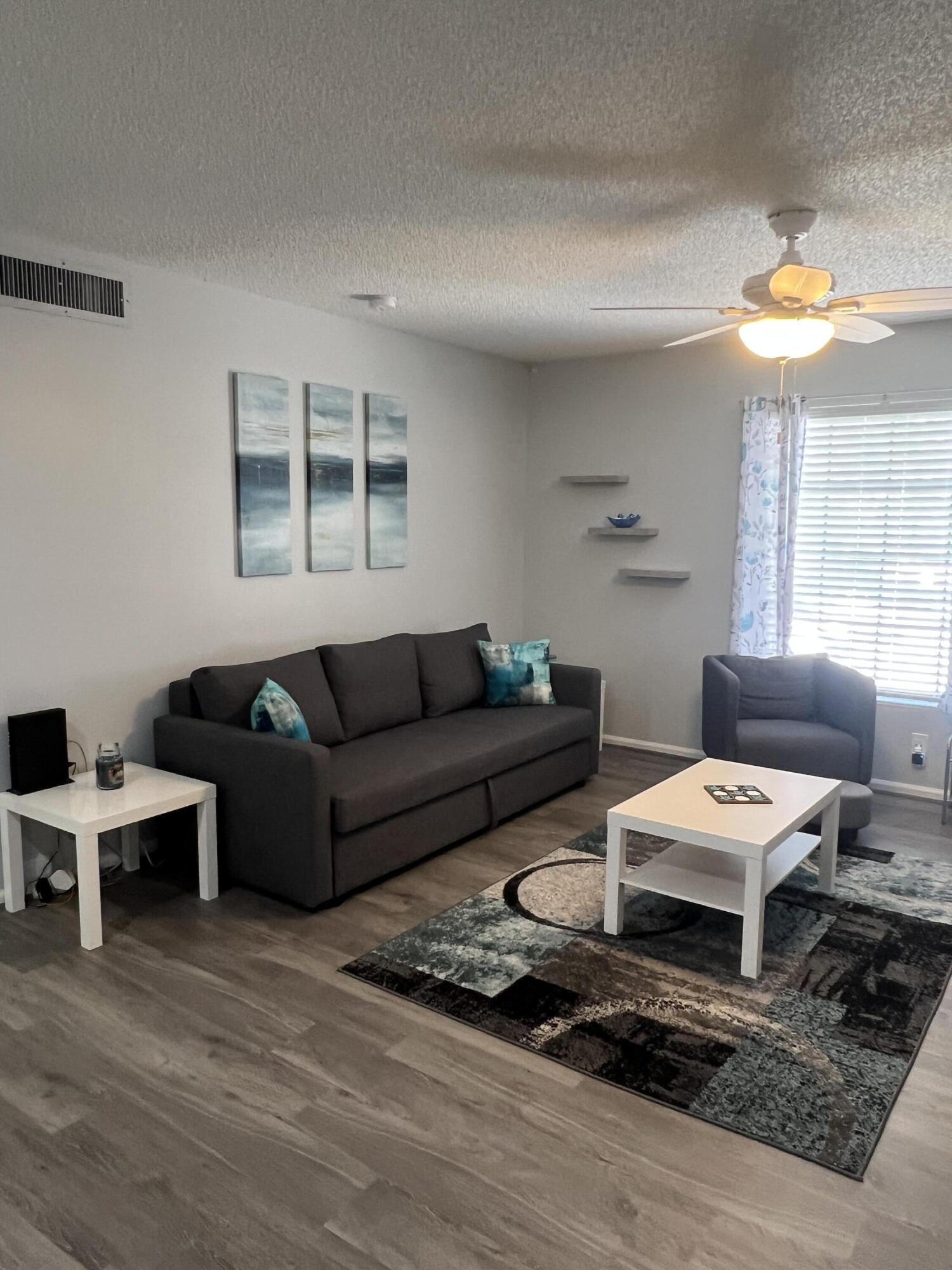 2271 Northeast 68th Street, Unit 2022 Fort Lauderdale, FL 33308 - Photo 6 of 22 a living room with furniture and a large window