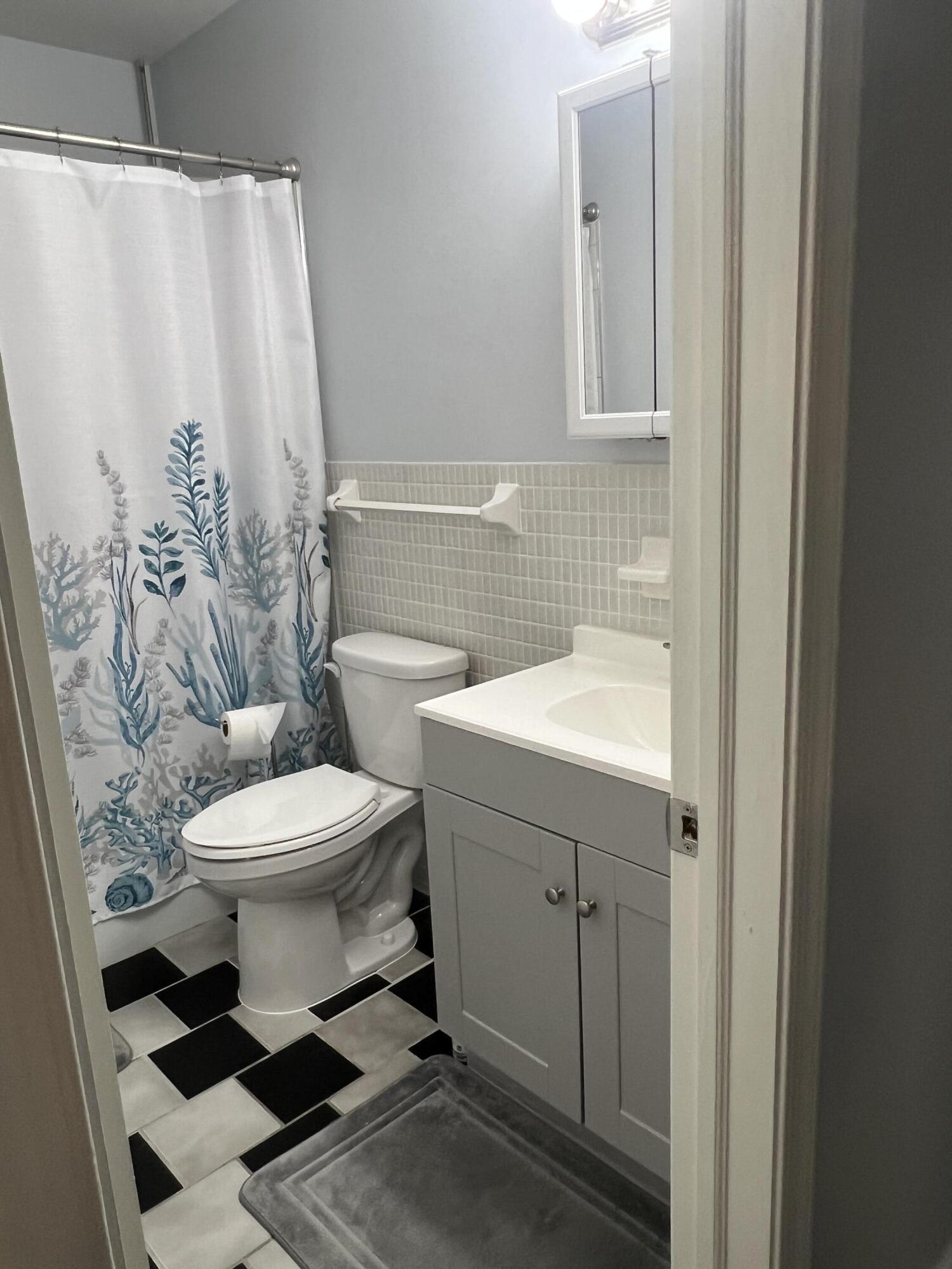 2271 Northeast 68th Street, Unit 2022 Fort Lauderdale, FL 33308 - Photo 7 of 22 a bathroom with a toilet sink and shower