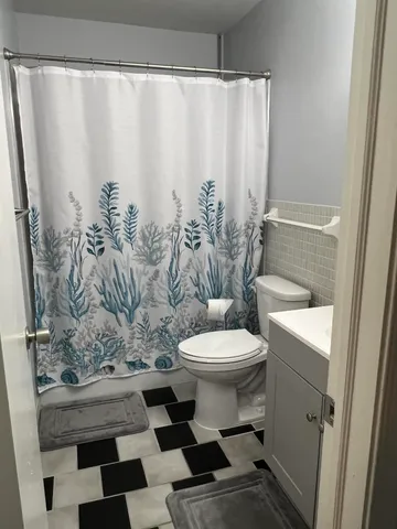 a bathroom with a toilet and shower