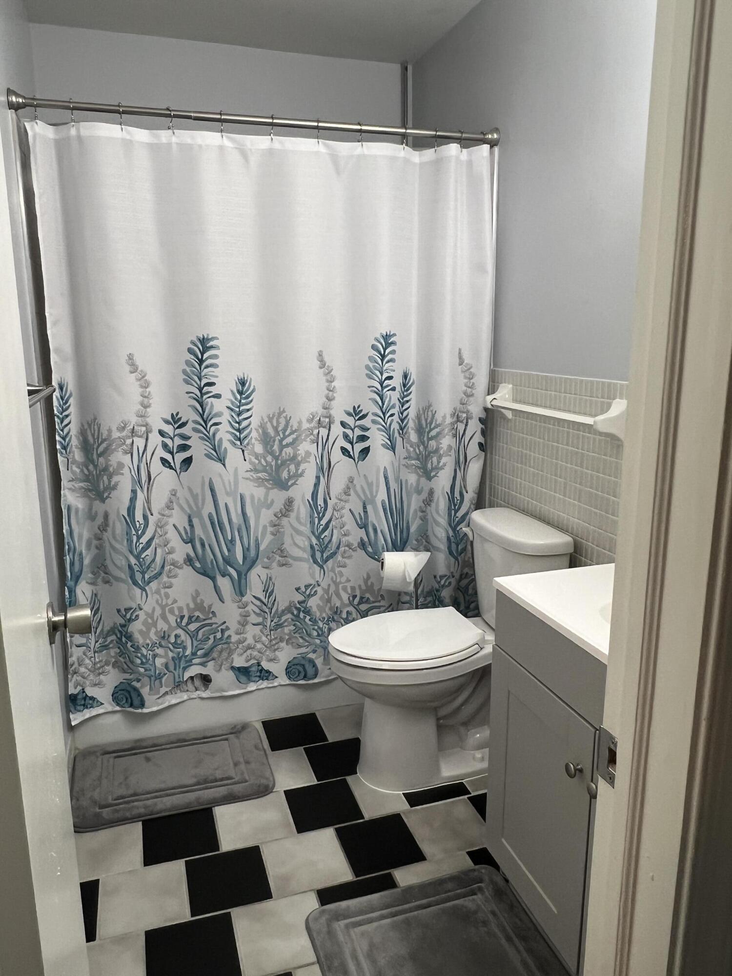 2271 Northeast 68th Street, Unit 2022 Fort Lauderdale, FL 33308 - Photo 8 of 22 a bathroom with a toilet and shower