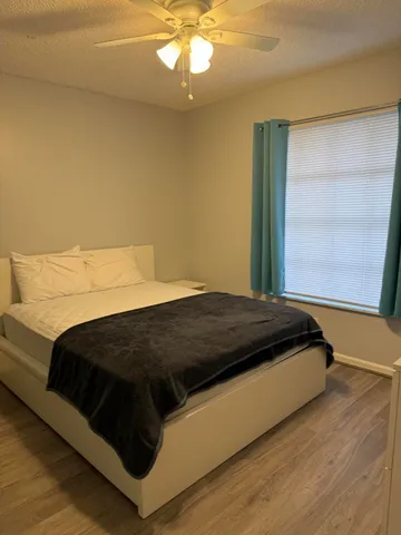 a bedroom with a bed and window