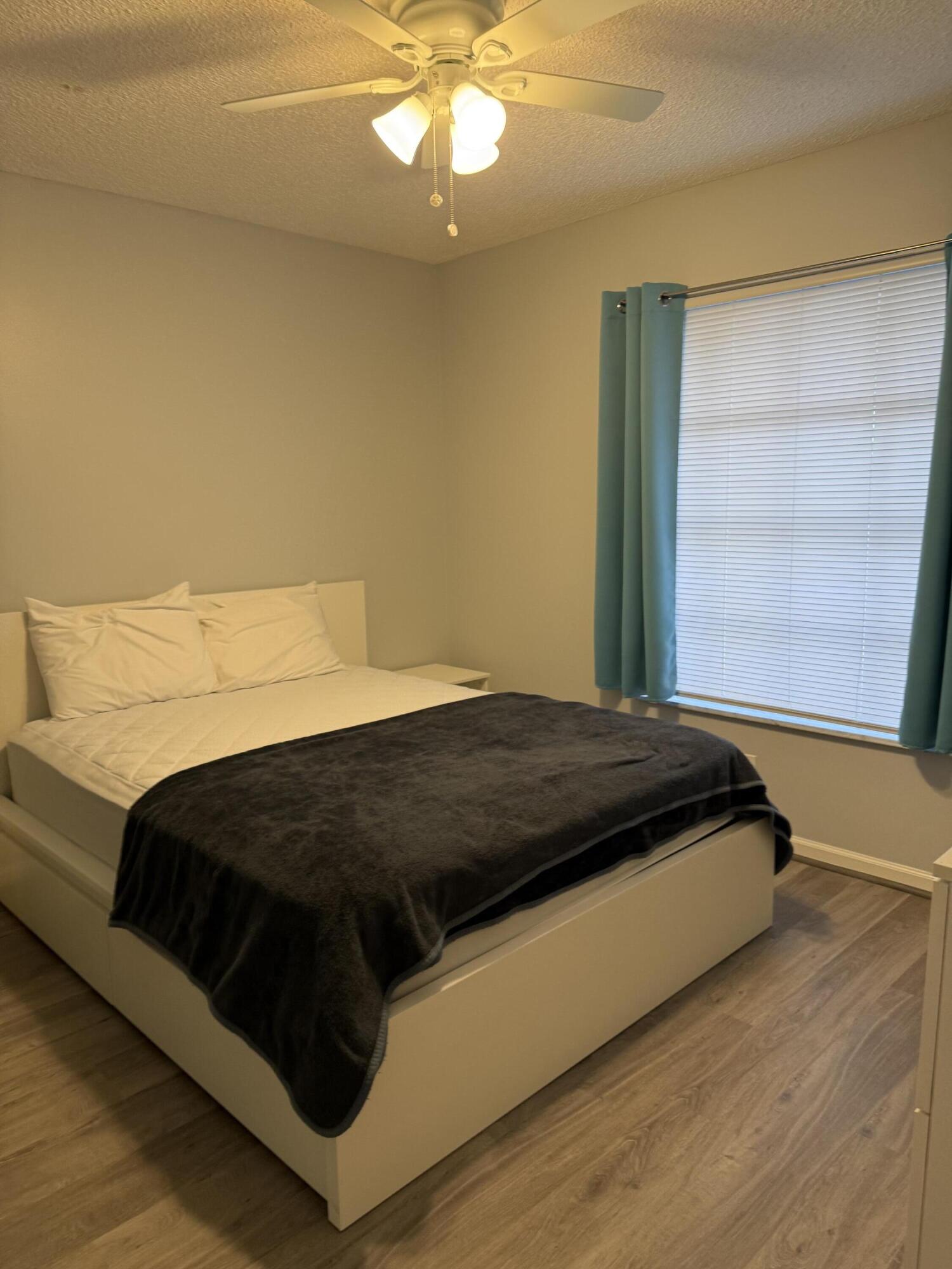 2271 Northeast 68th Street, Unit 2022 Fort Lauderdale, FL 33308 - Photo 9 of 22 a bedroom with a bed and window