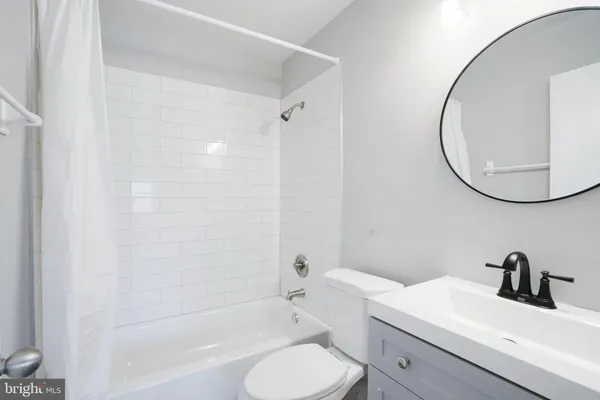 a bathroom with a toilet a sink and a mirror