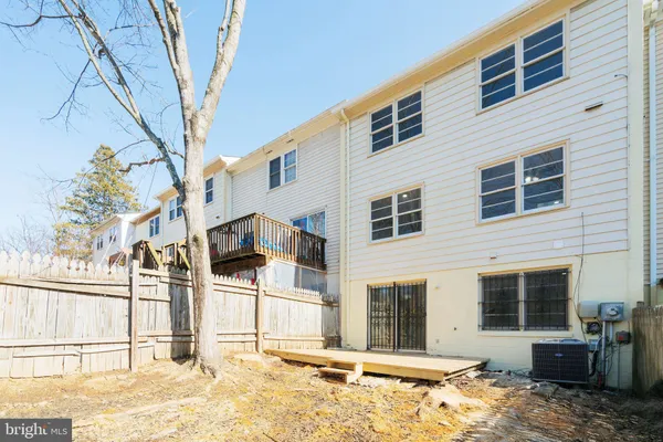 a view of backyard with wooden fence