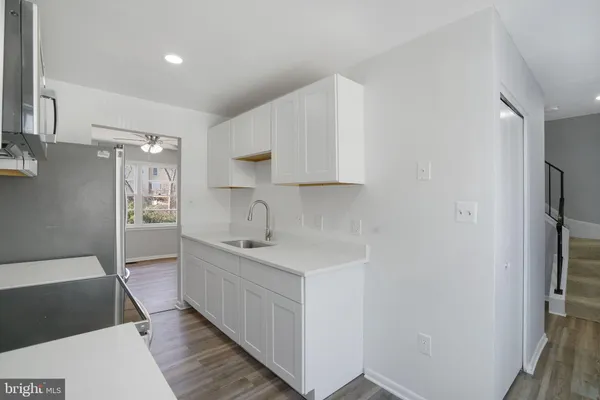 a kitchen with stainless steel appliances a sink stove and cabinets
