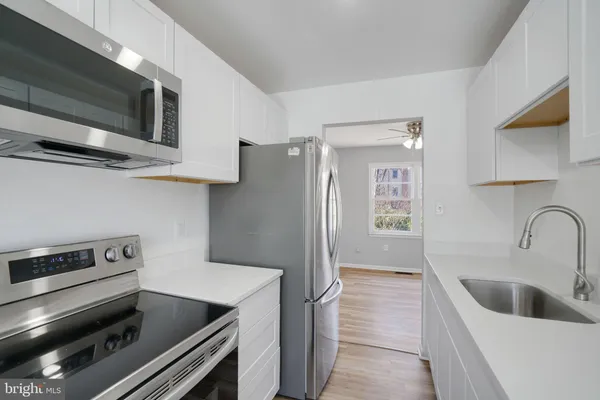 a kitchen with a refrigerator stove and microwave
